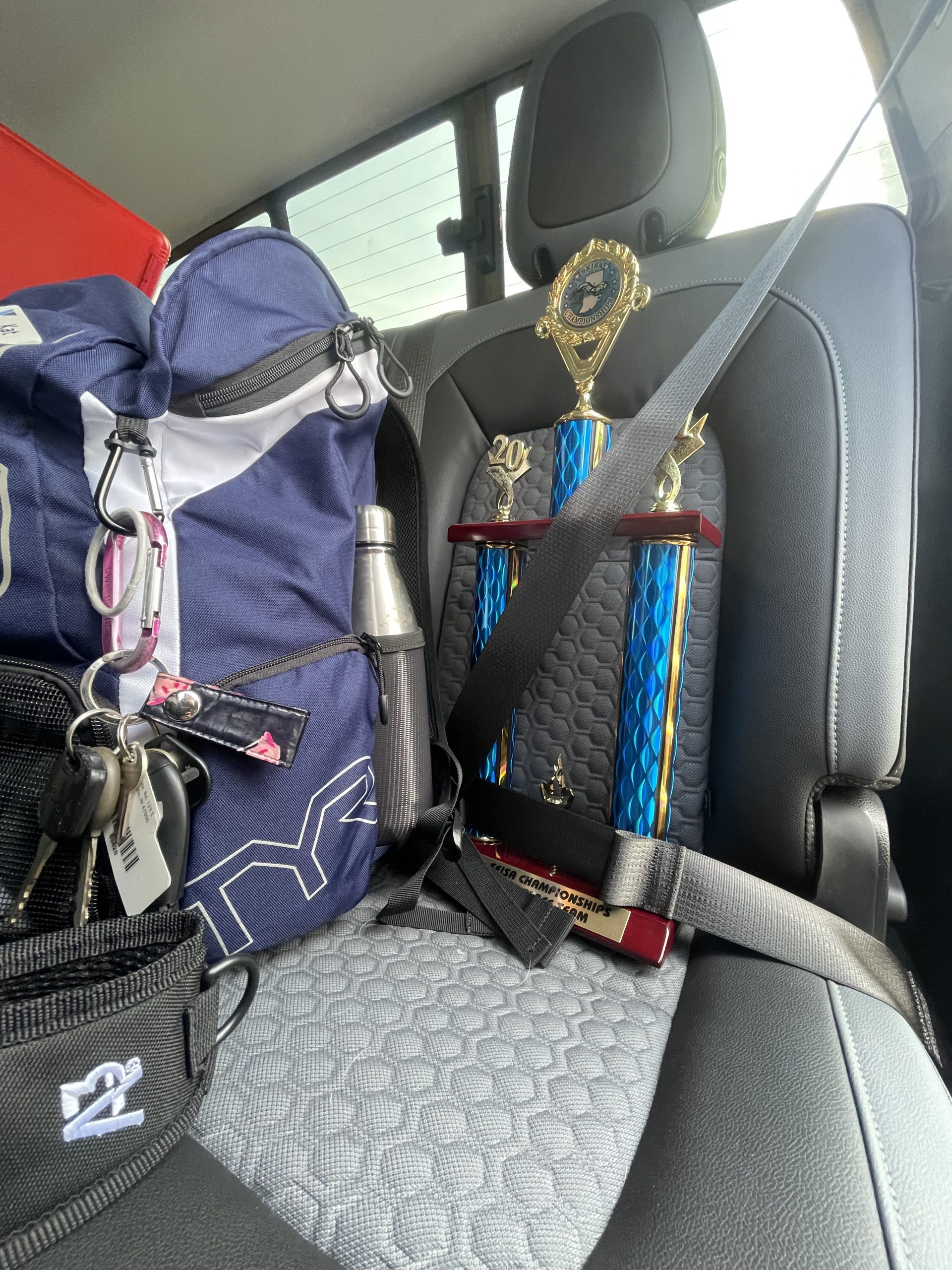 S.E.I.S.A. second place trophy strapped into back seat of the coach car